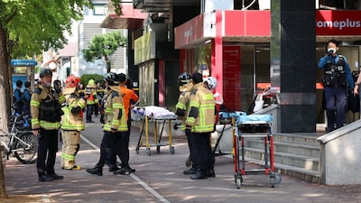Firefighters and policemen gather outside the scene where several people were injured in a stabbing incident in Incheon, South Korea, on October 13, 2026. (Photo: Yonhap via Reuters)