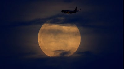 A full moon rises between clouds as a landing commercial jet approaches the airport in San Diego, California, US, January 20, 2019. Representational Image/Reuters