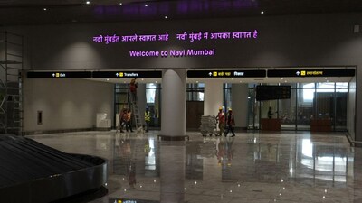 Workers move goods in a trolley at a baggage claim area inside the newly built Navi Mumbai International Airport, in Navi Mumbai, Maharashtra, India, December 17, 2025. File Image/Reuters