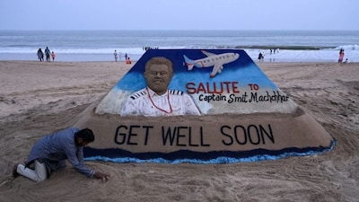 A sculpture made by India's sand artist Sudarsan Pattnaik depicts India's pilot Smit Machchhar, the captain of flydubai flight FZ 1073, at a beach in Odisha's Puri city on October 1, 2026.- Image- AFP
