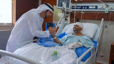In this photo provided by the Government of Dubai Media Office, Dubai Crown Prince Sheikh Hamdan bin Mohammed bin Rashid Al Maktoum, left, visits injured Indian Flydubai Capt. Smit Machchhar at a hospital in Abu Dhabi, United Arab Emirates, Friday, Oct. 2, 2026. (Government of Dubai Media Office via AP)
