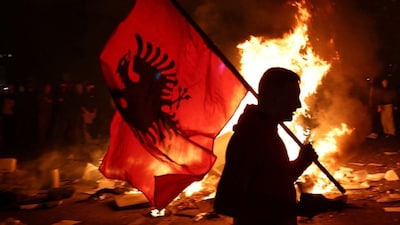 A protester holds an Albanian national flag as Albanian students hold an anti-government protest in Tirana, Albania, October 13, 2026. Reuters