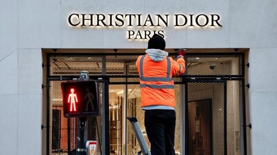 Workers repair the storefront of a damaged Christian Dior store and install a security gate a day after clashes during a national day of demonstrations against the cost of living and rising fuel prices in Paris. Reuters