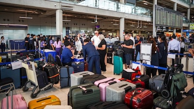 Passengers queue to claim baggage from Thai Airways flights at Suvarnabhumi International Airport, after heavy rain and flooding disrupted the airline's ground operations, in Bangkok, Thailand, September 29, 2026. REUTERS