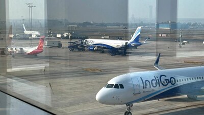 Two Indigo Airlines planes are seen through a glass window at the Indira Gandhi International Airport in New Delhi as several flights operated by the carrier were either cancelled or delayed, India, Thursday, Dec. 4, 2025.  AP