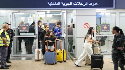 Passengers from an earlier diverted flydubai flight are seen after landing at Israel's Ben Gurion Airport in Lod. AFP