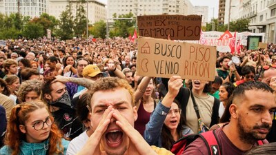 People demonstrate to demand stronger laws to protect renters in Madrid, Spain. The banner reads in Spanish: "Looking for an apartment, selling a kidney". AP