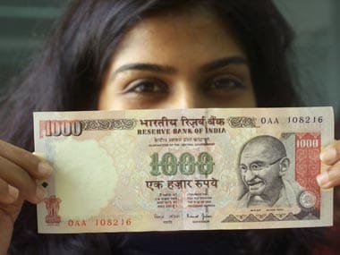 A GIRL DISPLAYS THE NEWLY INTRODUCED 1000 RUPEE NOTE IN BOMBAY. Sexing the Mahatma