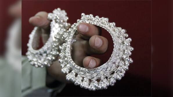 Silver prices plunge nearly 20%, but recover mildly