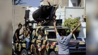 Rebels take Gaddafi's compound, son says dictator is in Libya