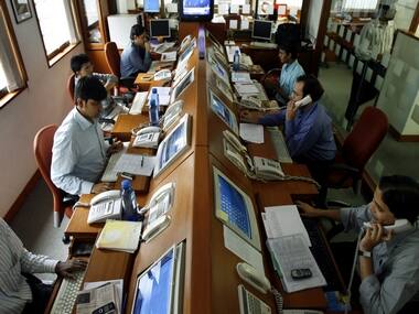 Stockbrokers trade on their screens at a brokerage firm in Mumbai