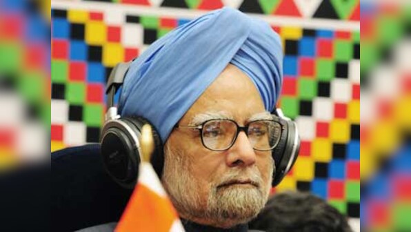 Journalists get a piece of cake from birthday boy Manmohan