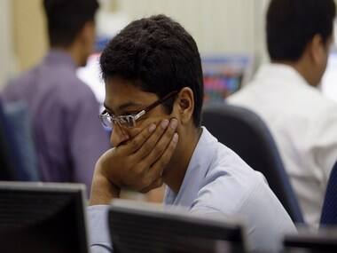 A trader looks on while trading at a stock brokerage in Mumbai