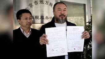Police charge Ai Weiwei with porn, fans strip in support