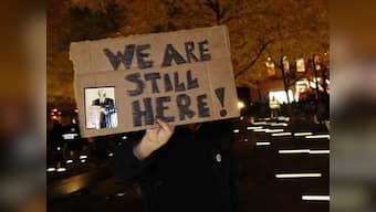Occupy Wall St activists break police barriers, take back park