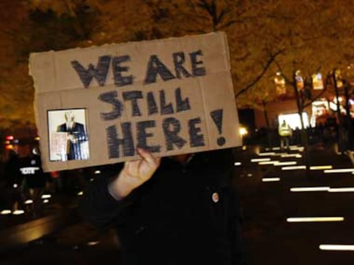 Occupy Wall St activists break police barriers, take back park