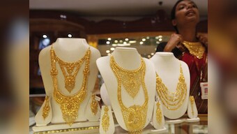 Gold futures ease from one-week high, falls on easing eurozone fears