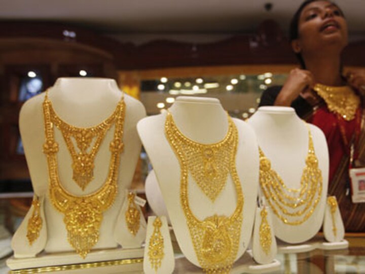 Gold futures ease from one-week high, falls on easing eurozone fears