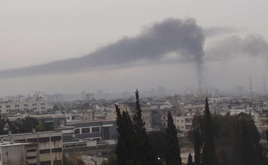 Smoke billows in Homs in this handout picture received February 17. Reuters Smoke billows in Homs in this handout picture received February 17. Reuters