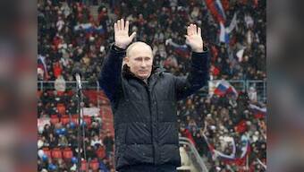 Putin warns against foreign influence as thousands rally in support