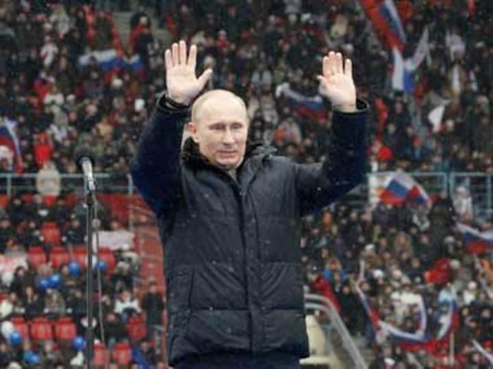 Putin warns against foreign influence as thousands rally in support