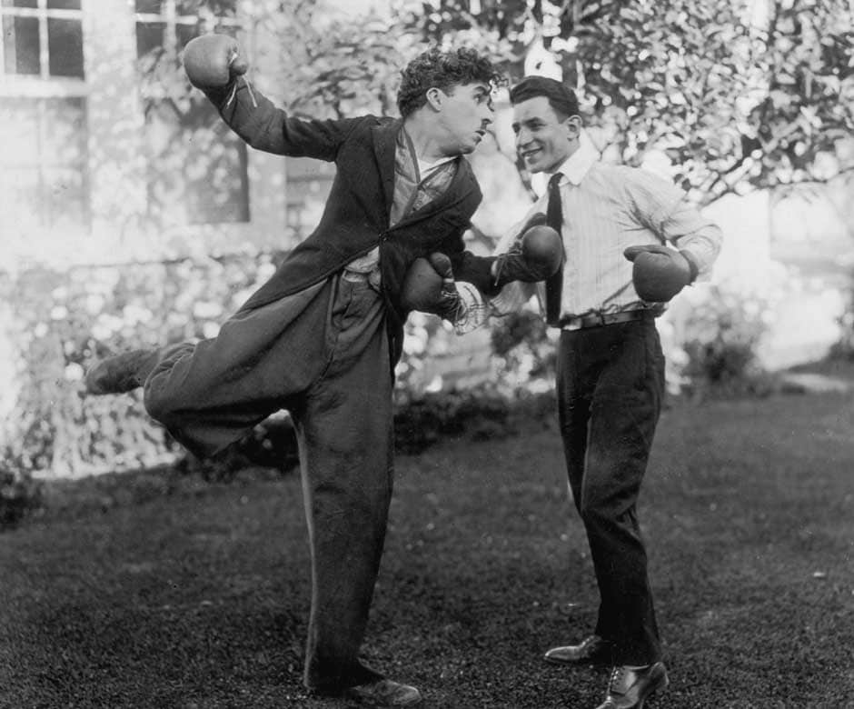 Charlie Chaplin (Sir Charles Spencer Chaplin, 1889 - 1977), English film actor and director larking with British flyweight boxer Harry Mansell. Getty Images Charlie Chaplin (Sir Charles Spencer Chaplin, 1889 - 1977), English film actor and director larking with British flyweight boxer Harry Mansell. Getty Images