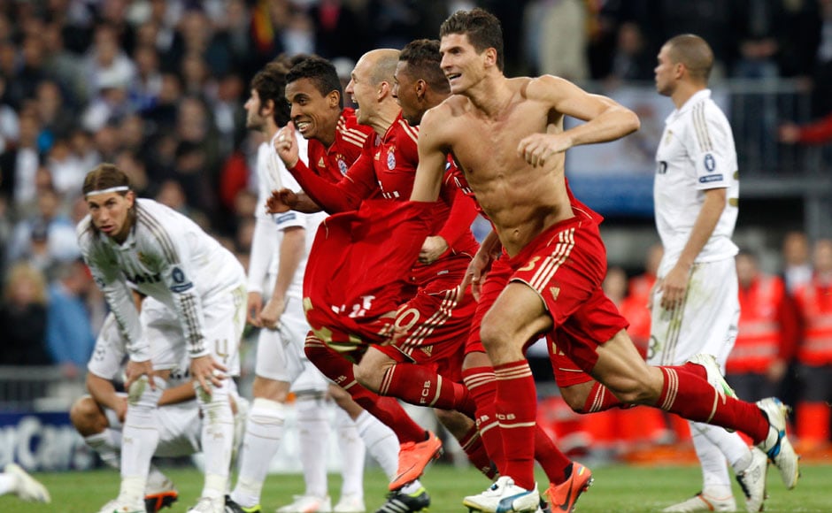  Real Madrid and Bayern Munich players celebrate their victory in the semi-finals of the 2013/14 UEFA Champions League.