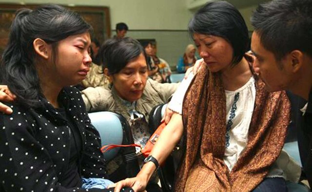 Relatives weep as they wait for news on the missing Russian airplane at Halim Perdanakusuma Airport in Jakarta. AP