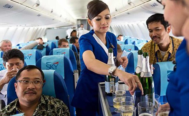 Cabin crew serving passengers before the plane crashed in Indonesia. AP