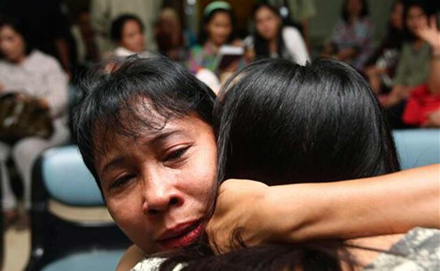 A relative weeps as she and others wait for the latest news on the Russian passenger jet. AP