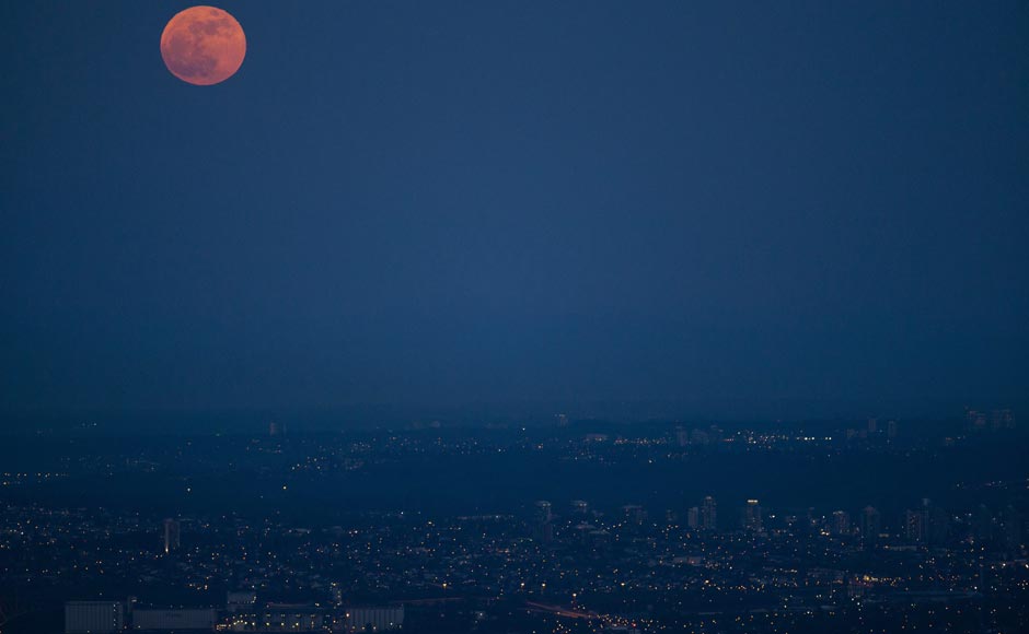 The supermoon is seen rising over Vancouver, British Columbia. AP The supermoon is seen rising over Vancouver, British Columbia. AP