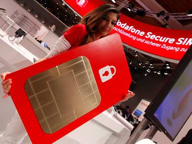 A staff member poses with a mock oversized Vodafone Secure SIM card at the Vodafone booth at the CeBit computer fair in Hanover New deals. Reuters