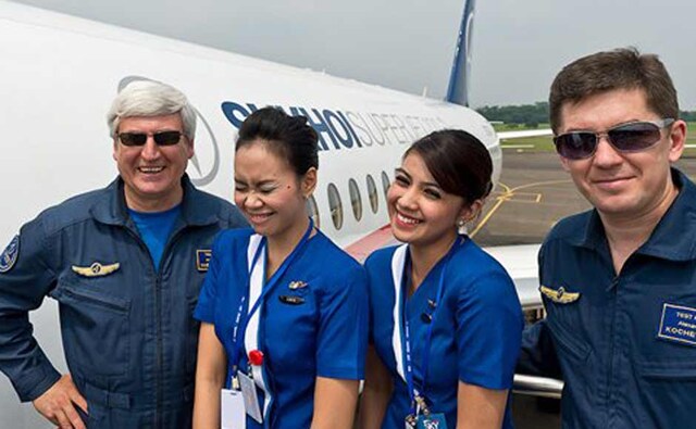 Captain pilot Alexander Yablontsev, officer Alexander Kotchetkov with cabin crew next to their Sukhoi Superjet-100 prior to a demonstration flight. AP