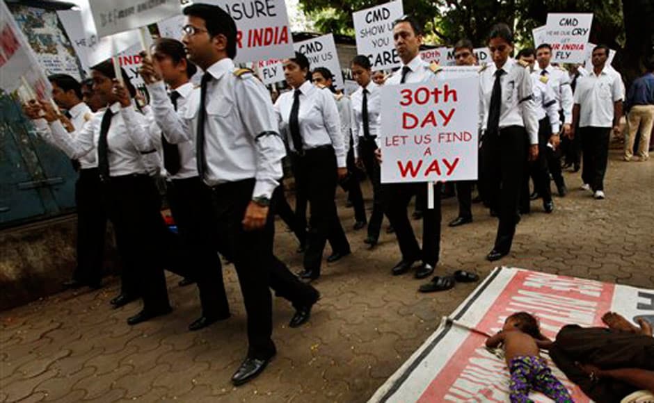 On the 30th day of the Air India strike, pilots participate in a silent protest march against Air India's management, in New Delhi on 6 June, 2012. AP On the 30th day of the Air India strike, pilots participate in a silent protest march against Air India's management, in New Delhi on 6 June, 2012. AP