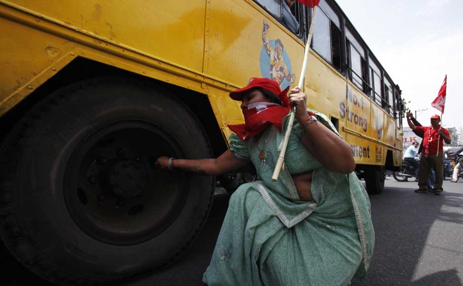 How dare they run buses while I'm striking, let's puncture the damn tyres: A left party activist deflates a tire of a bus during a nationwide strike against a steep hike in gas prices in Hyderabad. Mahesh Kumar A/ AP How dare they run buses while I'm striking, let's puncture the damn tyres: A left party activist deflates a tire of a bus during a nationwide strike against a steep hike in gas prices in Hyderabad. Mahesh Kumar A/ AP
