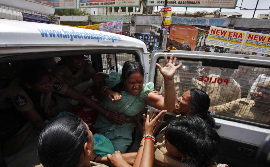 I'm so angry even five of you can't detain me:A left party activist beats a police woman as she is detained during a nationwide strike against a steep hike in gas prices in Hyderabad. Mahesh Kumar A/AP I'm so angry even five of you can't detain me:A left party activist beats a police woman as she is detained during a nationwide strike against a steep hike in gas prices in Hyderabad. Mahesh Kumar A/AP
