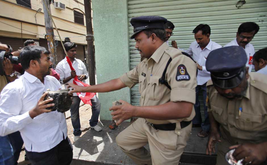 Ok I'm not really angry, I just want to use this bandh as an excuse to get my hands on some booze: Policemen stop activists of left parties who tried to attack a wine shop which was open during a nationwide strike against a steep hike in gas prices in Hyderabad. Mahesh Kumar A/AP Ok I'm not really angry, I just want to use this bandh as an excuse to get my hands on some booze: Policemen stop activists of left parties who tried to attack a wine shop which was open during a nationwide strike against a steep hike in gas prices in Hyderabad. Mahesh Kumar A/AP