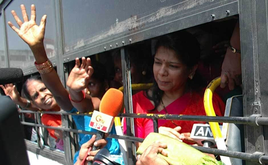 Kanimozhi in a bus waving to DMK supporters. Firstpost Kanimozhi in a bus waving to DMK supporters. Firstpost