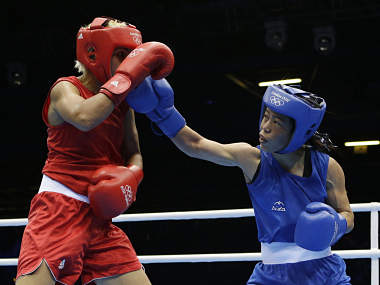 Mary Kom beats Rahali, assures India of bronze Mary Kom beats Rahali, assures India of bronze