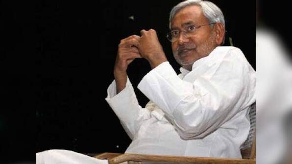 Nitish Kumar celebrates by tying rakhi to trees