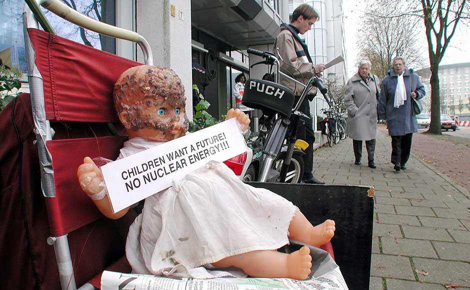 <br />Pedestrians walk towards a burnt doll place there by an anti-nuclear protester outside the 6th United Nations Conference on Climate Control 14 November 2000 in The Hague, The Netherlands. Michel Porro/Newsmakers <br />Pedestrians walk towards a burnt doll place there by an anti-nuclear protester outside the 6th United Nations Conference on Climate Control 14 November 2000 in The Hague, The Netherlands. Michel Porro/Newsmakers