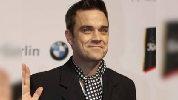 Pop star Robbie Williams becomes a dad