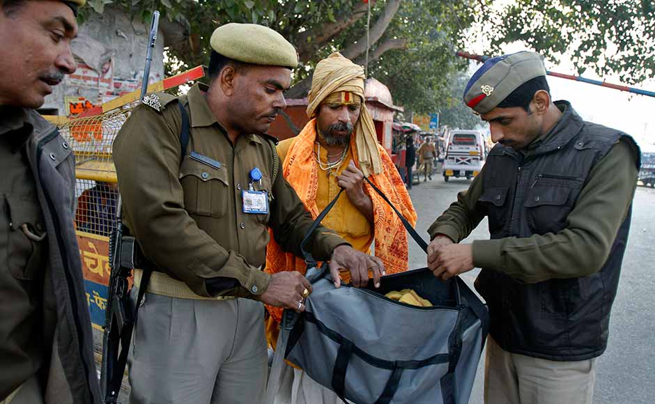 Policemen check the luggage of a Hindu holy man at the town border on the eve of the anniversary of the Babri mosque demolition in Ayodhya. Rajesh Kumar Singh/AP Policemen check the luggage of a Hindu holy man at the town border on the eve of the anniversary of the Babri mosque demolition in Ayodhya. Rajesh Kumar Singh/AP