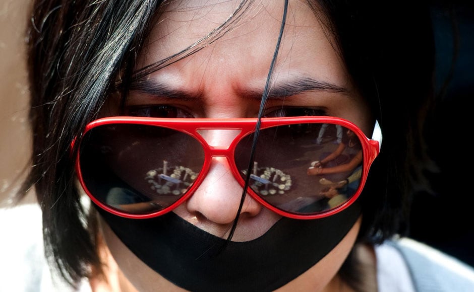 A woman protests against the brutal incident that took the life of the young woman by tying a black band on her face. Naresh Sharma/ Firstpost A woman protests against the brutal incident that took the life of the young woman by tying a black band on her face. Naresh Sharma/ Firstpost