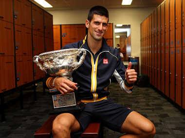 Novak Djokovic of Serbia poses with the Norman Brookes Challenge Cup in the change rooms after the final. Getty Images