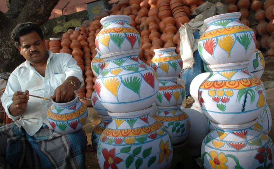 A claypot-vendor decorating his ware for the season. Firstpost A claypot-vendor decorating his ware for the season. Firstpost