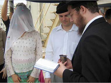 In this picture Rabbi Gavriel Holtzberg, right performed a Jewish wedding in Mumbai in India in 2006 as his wife Rivka Holtzberg, left looked on. Reports indicate the couple may have been brutally tortured before being killed by the terrorists.
