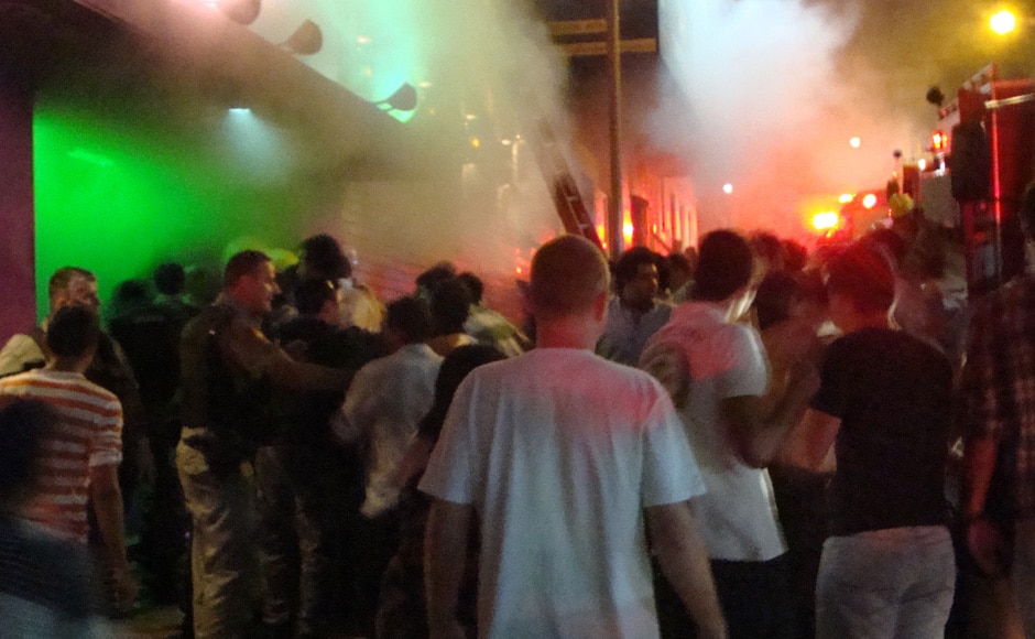A crowd stands outside the Kiss nightclub after a fire broke out inside the club in Santa Maria city, Rio Grande do Sul state, Brazil on Sunday. AP