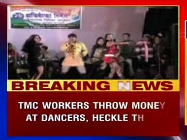 Party workers throw money at women dancers during TMC celebrations Party workers throw money at women dancers during TMC celebrations