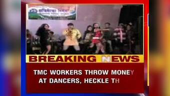 Party workers throw money at women dancers during TMC celebrations 